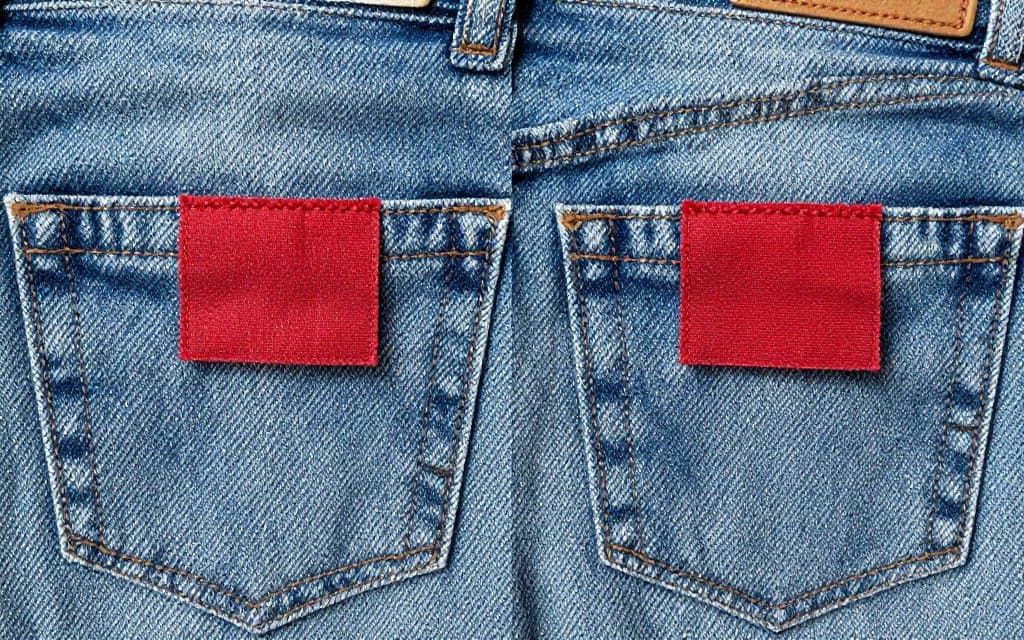 Comparison of Big E and small e red tabs on vintage Levis jeans back pockets