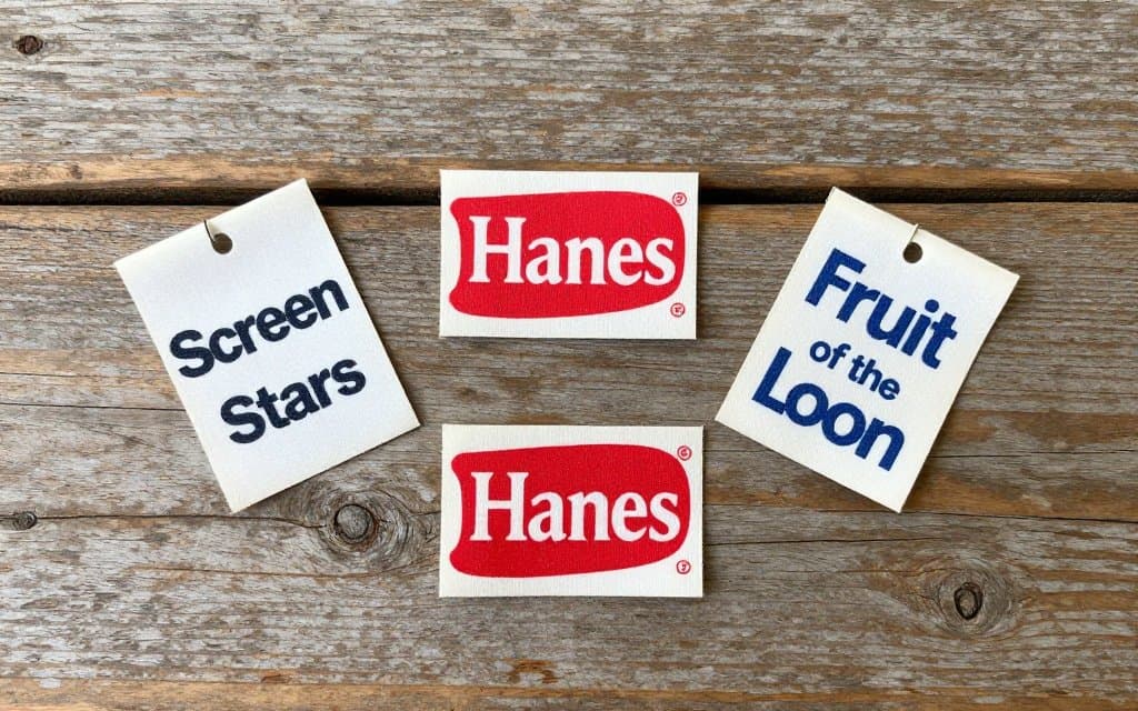 Top-down vintage tshirt tags from Screen Stars, Hanes, and Fruit of the Loom