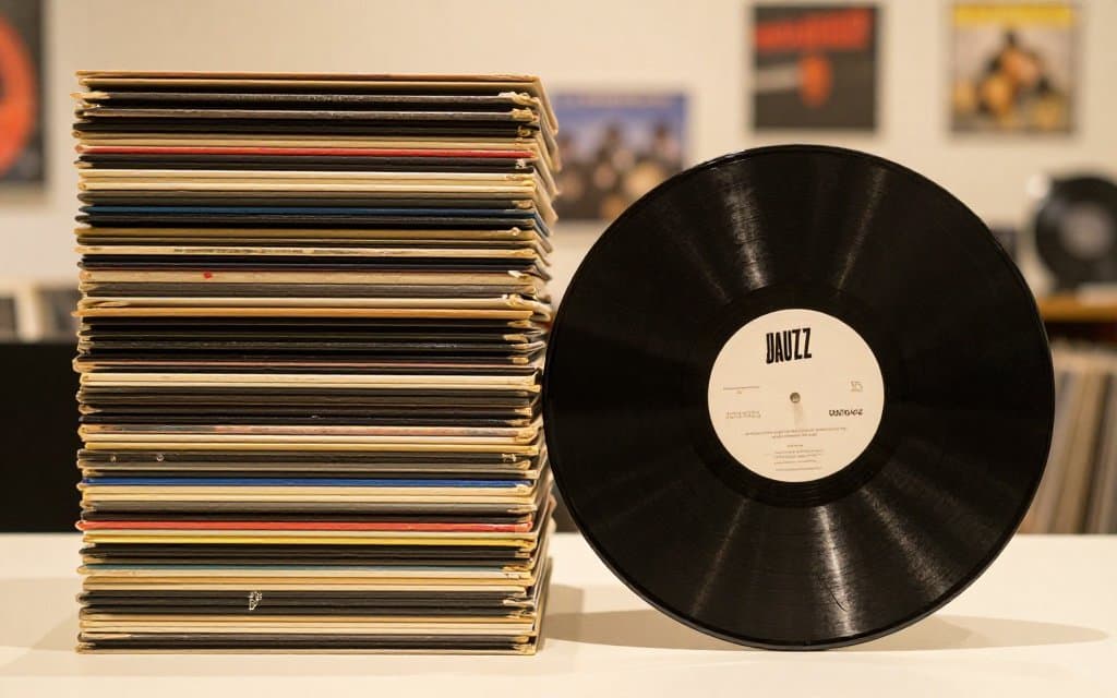 Common records beside a rare jazz pressing among records worth money at a thrift store.