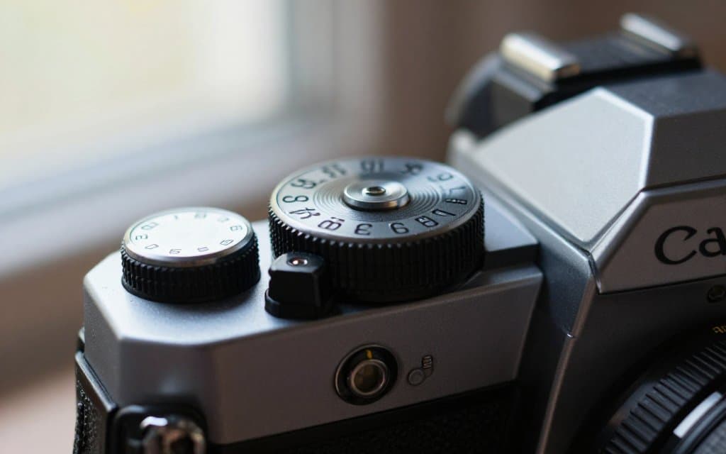 Macro view of a Canon AE-1 film camera top plate showing the shutter dial and serial number