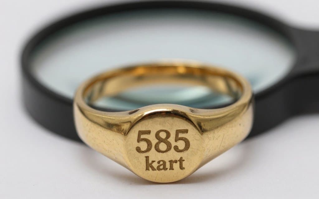 Macro of a 585 hallmark stamp inside a gold ring, how to tell if gold is real