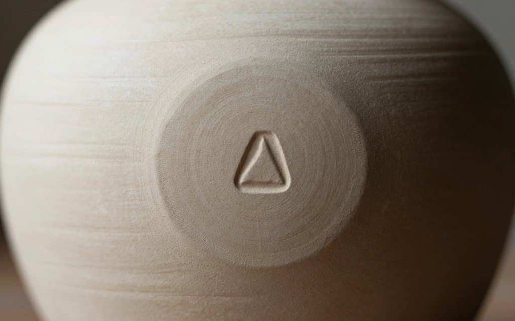 Macro of impressed pottery marks on the base of a vintage vase