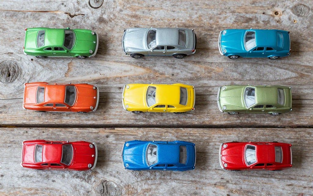 Top down flat lay of rare Hot Wheels redline cars in metallic Spectraflame colors