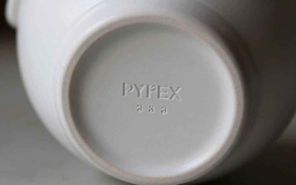 Macro close-up of a vintage Pyrex backstamp and number code on a bowl base