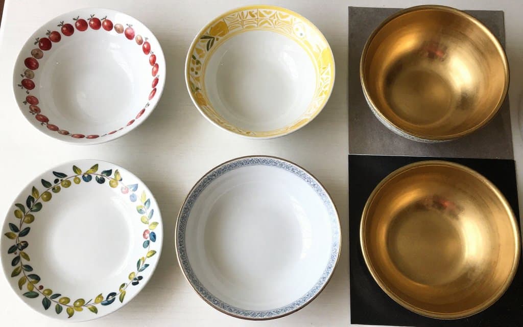 Several vintage Pyrex patterns compared side by side on a table
