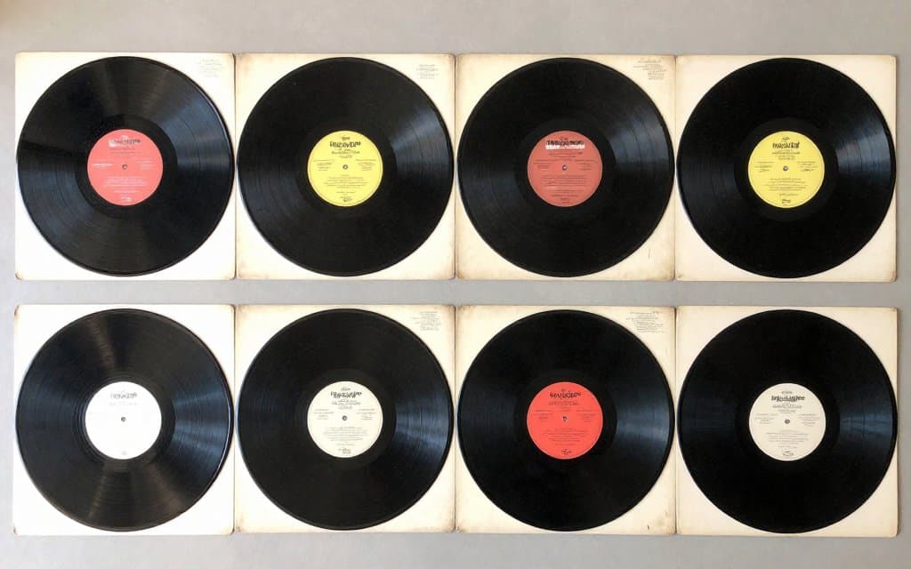 Top-down flat lay of collectible vinyl records worth money and their jackets
