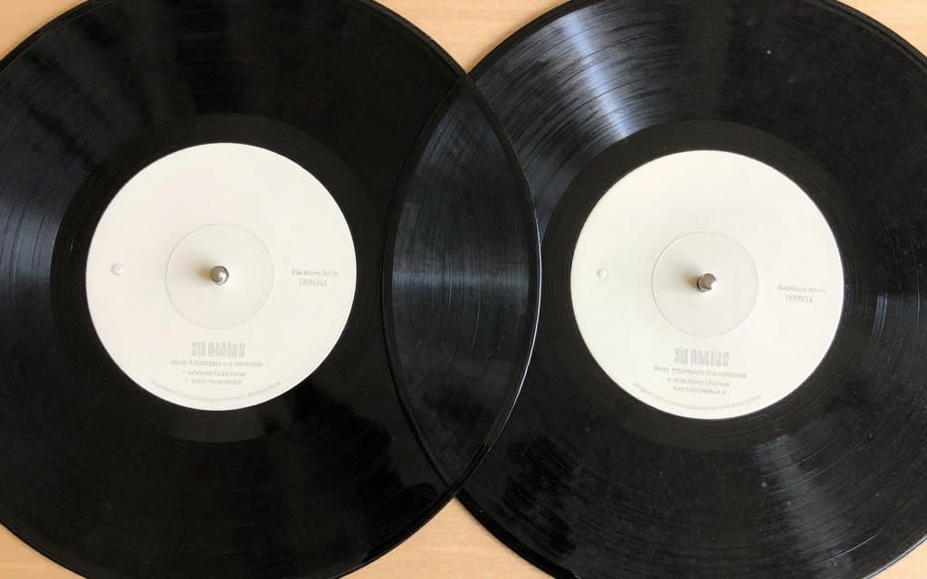 Two copies of the same vinyl record compared for condition and resale value