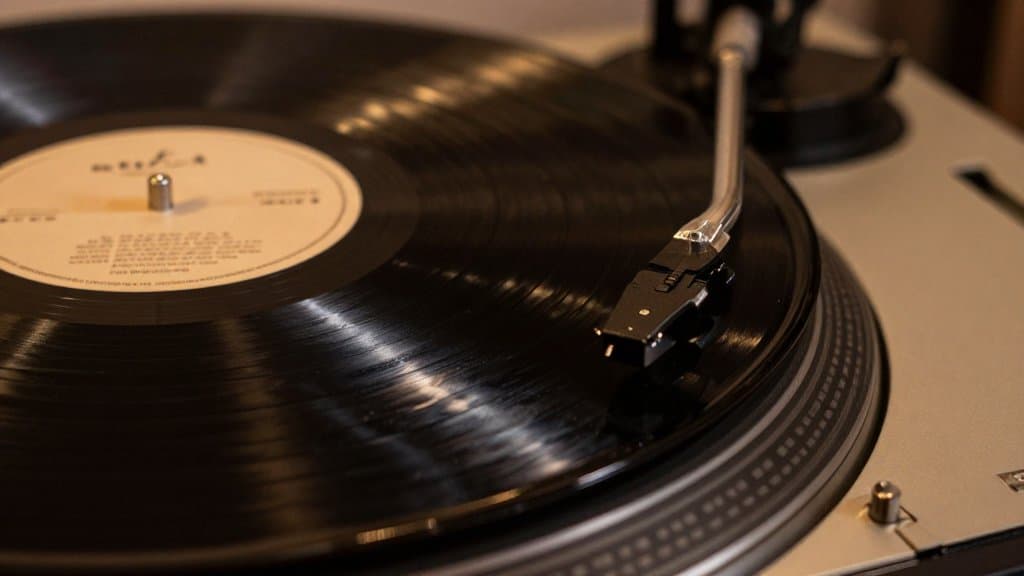 Close-up of the dead wax and runout groove on a black vinyl record near the label