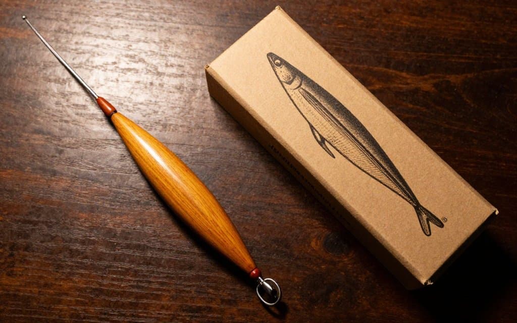 Antique wooden fishing lure displayed with its original box as a vintage fishing lures with box example
