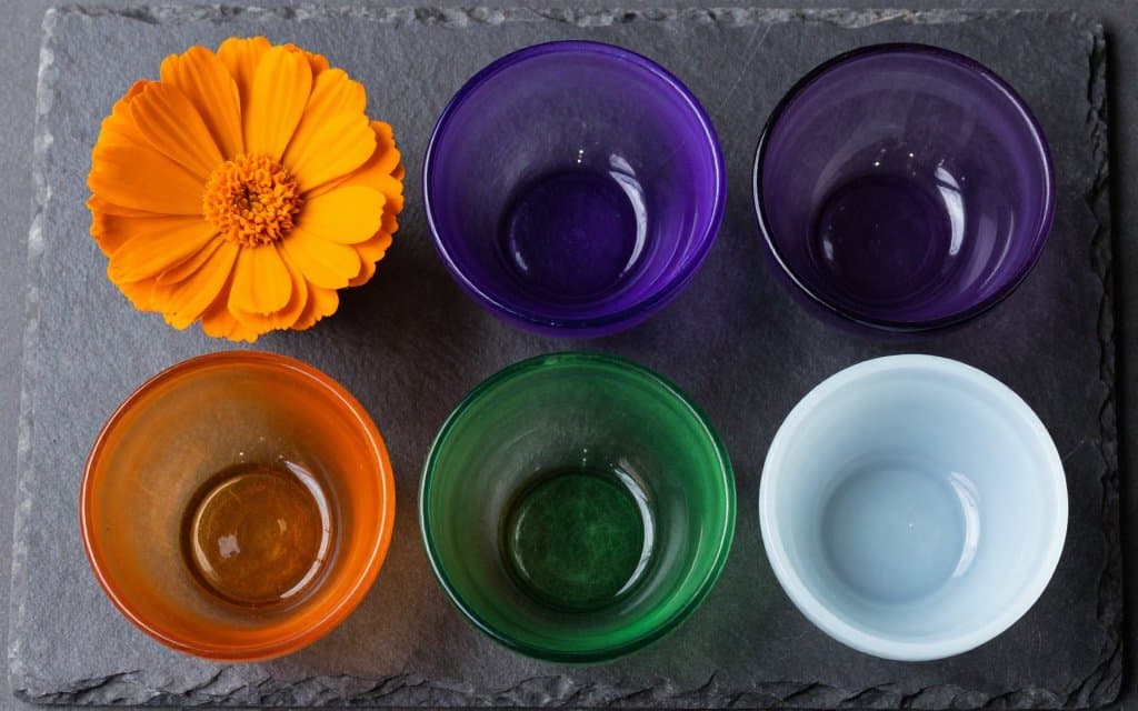 Bowls in marigold, amethyst, green and rare ice blue lined up to compare colors