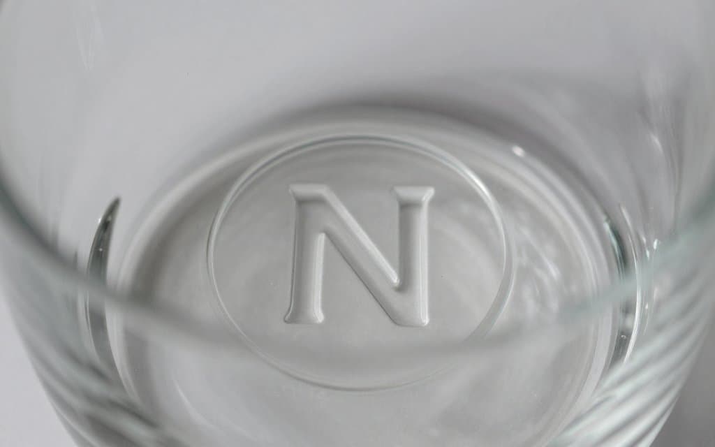Close up of the underlined N maker mark on the base of a Northwood iridescent bowl