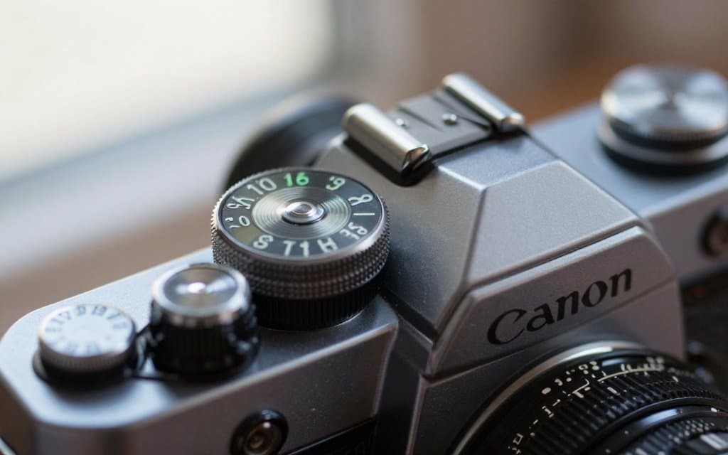 Macro view of a Canon AE 1 vintage camera top dial and film advance lever