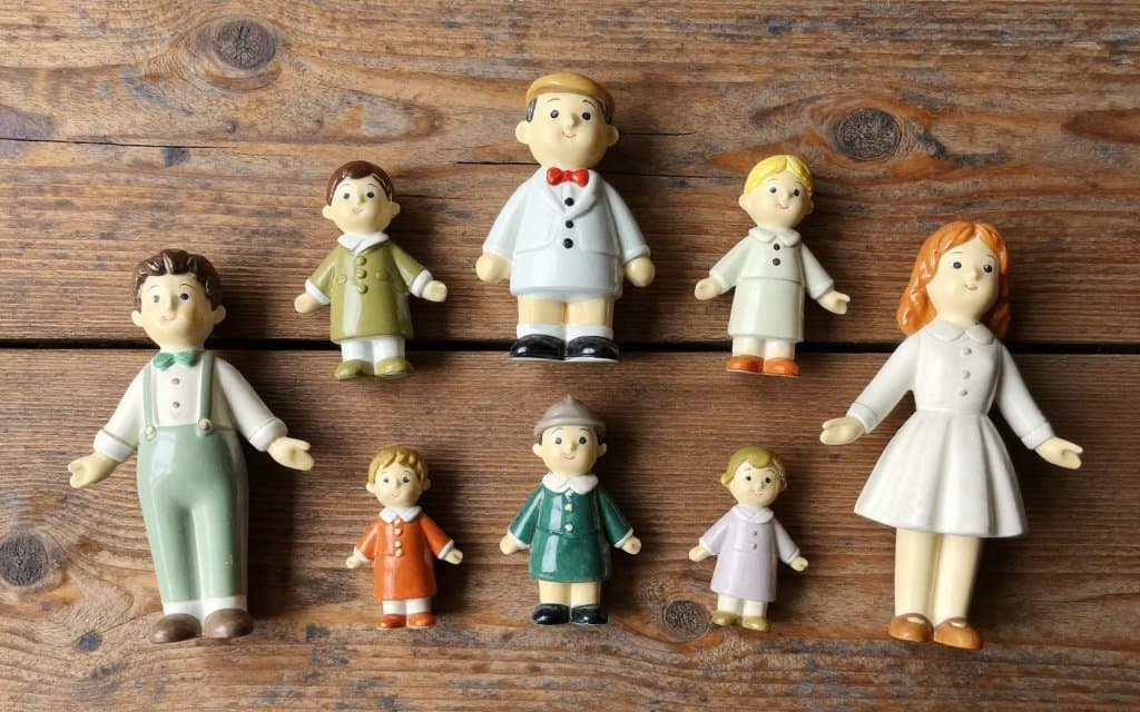 Top-down group of the most valuable Hummel figurines arranged on wood