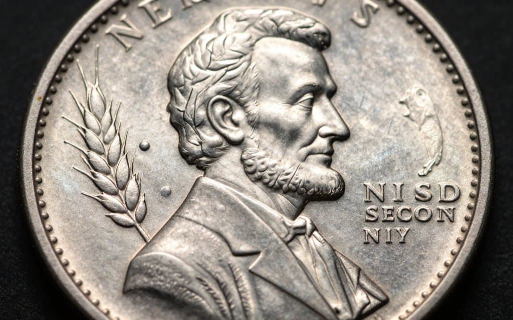 Macro view of a wheat penny reverse showing the two wheat ears, the design that names the coin.