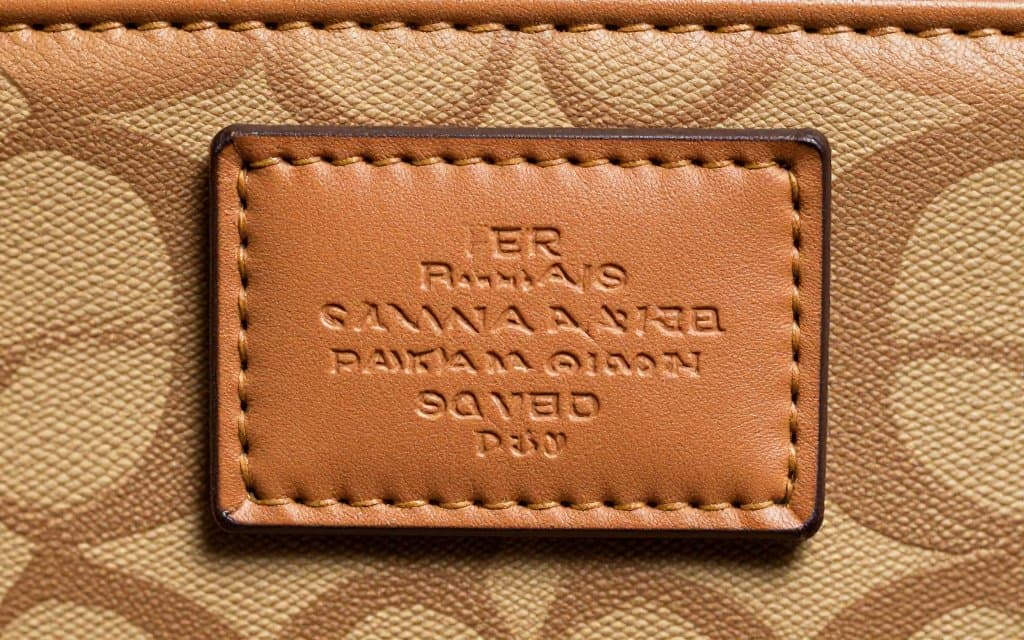 Macro of the creed patch and serial number to tell if a Coach bag is real