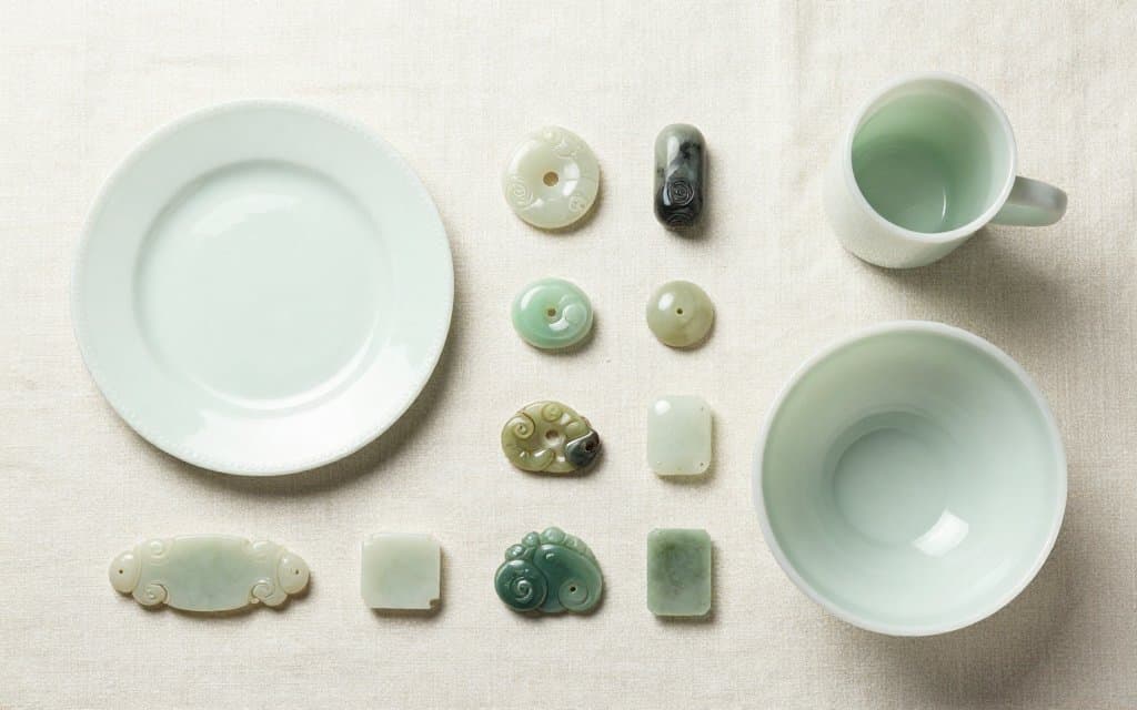 Top down flat lay of vintage jadeite dishes on linen showing shape variety
