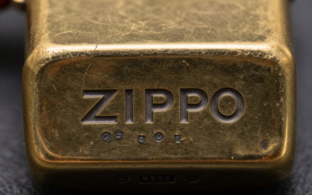 Macro view of a vintage Zippo lighter bottom stamp showing the logo and date code symbols.