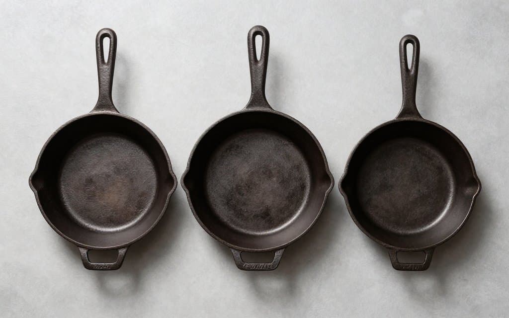 Top down comparison of Griswold logo eras on the base of each iron skillet