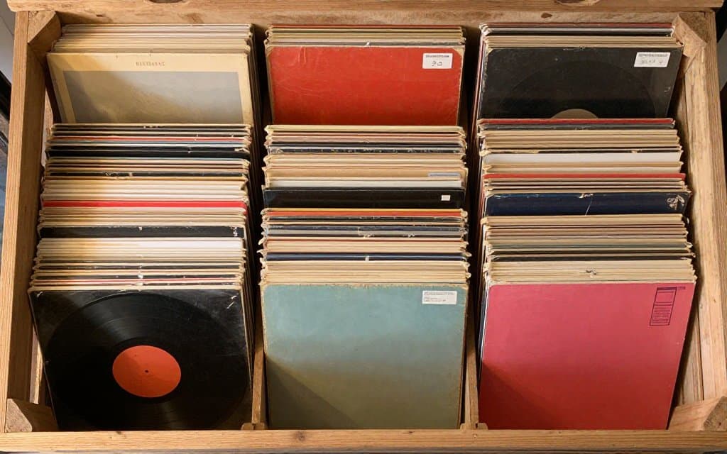 Top down thrift store crate packed with valuable vinyl records waiting to be sorted