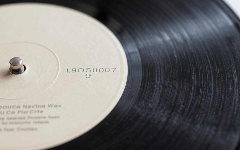 Macro of dead wax matrix numbers etched near a vinyl record label