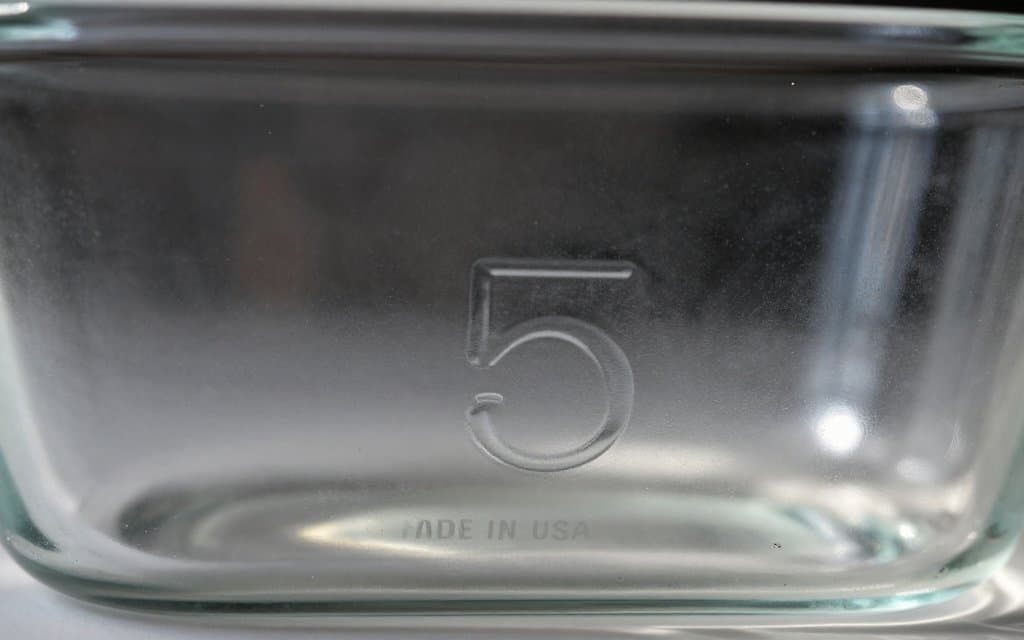 Close up of a vintage Pyrex backstamp showing the shape number and MADE IN USA mark on the base