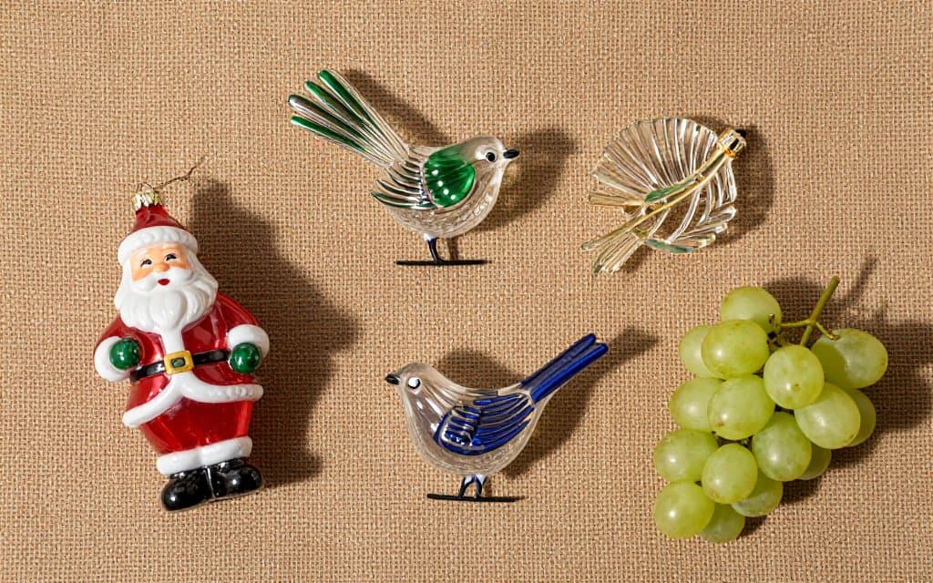 Top down view of vintage glass Santa ornaments and other German figural pieces